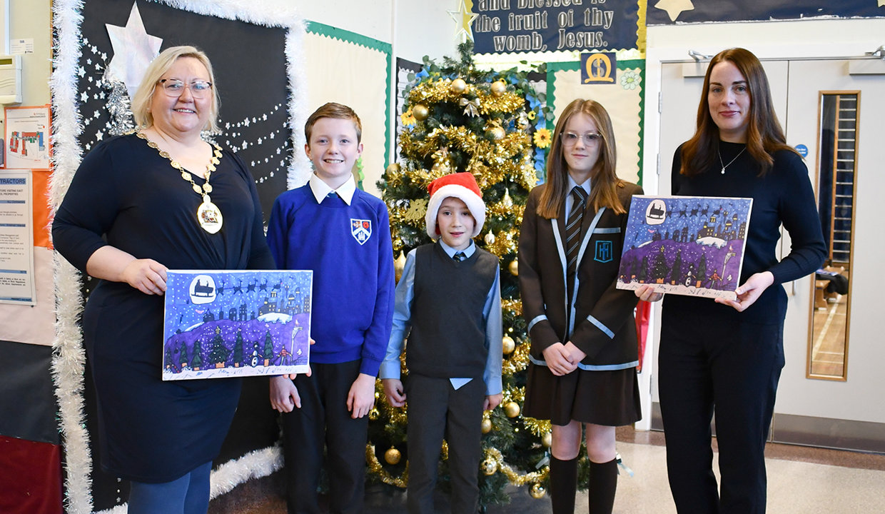 Anthony, Evan and Mya with Provost and deputy provost holding his winning entry