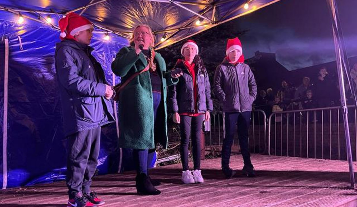 Provost on stage turning on the lights.