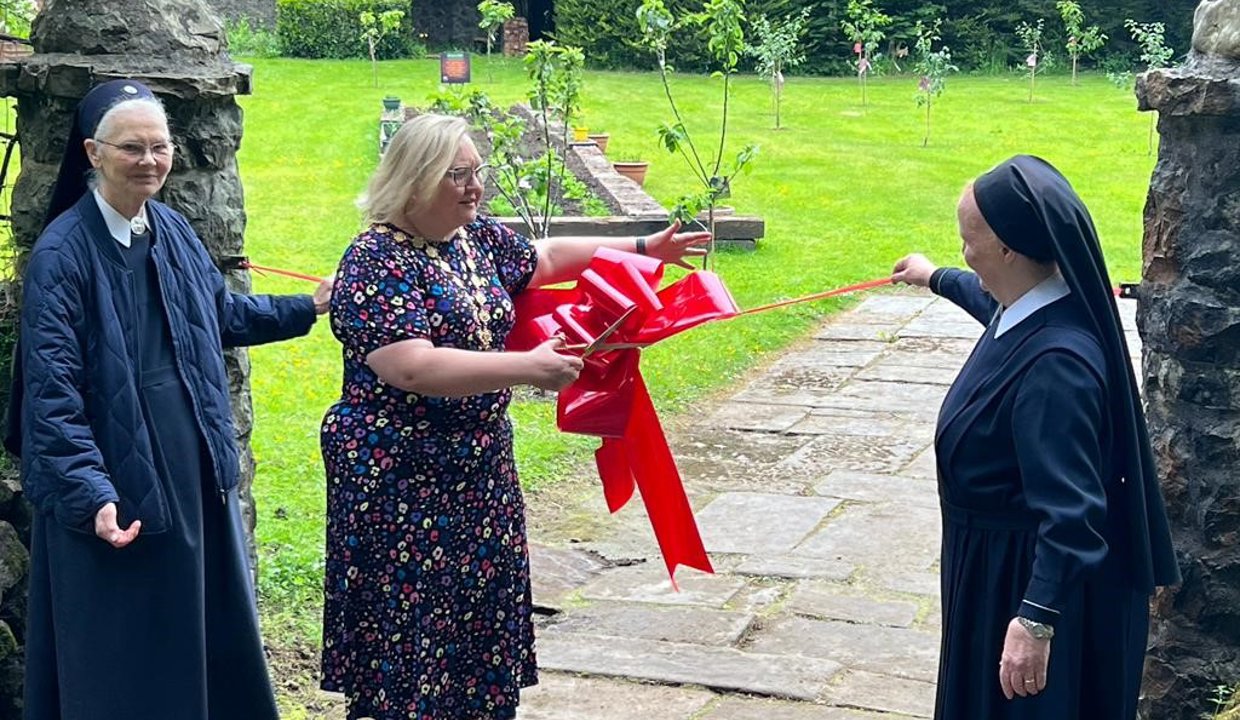 Provost Renwick and others at Schoenstatt Garden cutting the ribbon