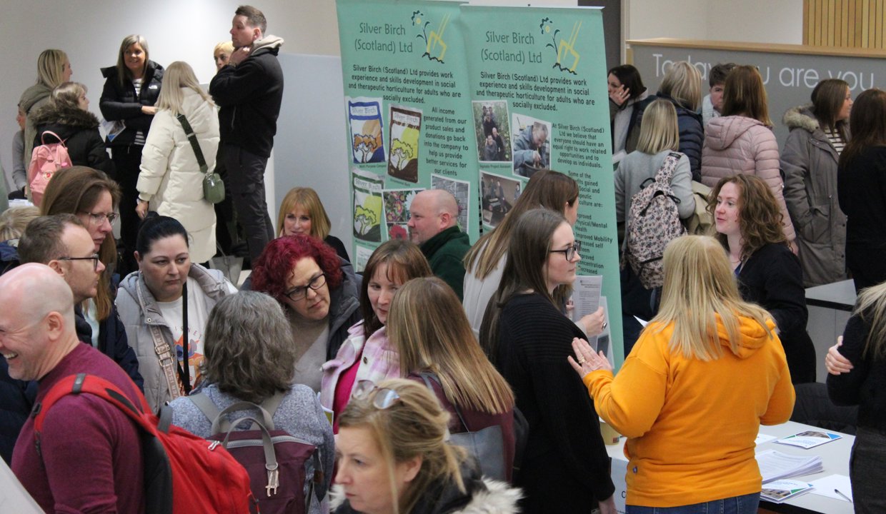 Participants mingle at information stalls.