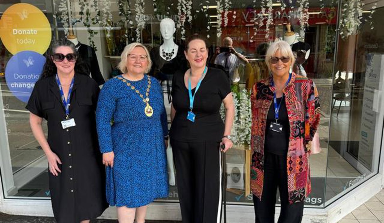Provost with shop staff outside the new store