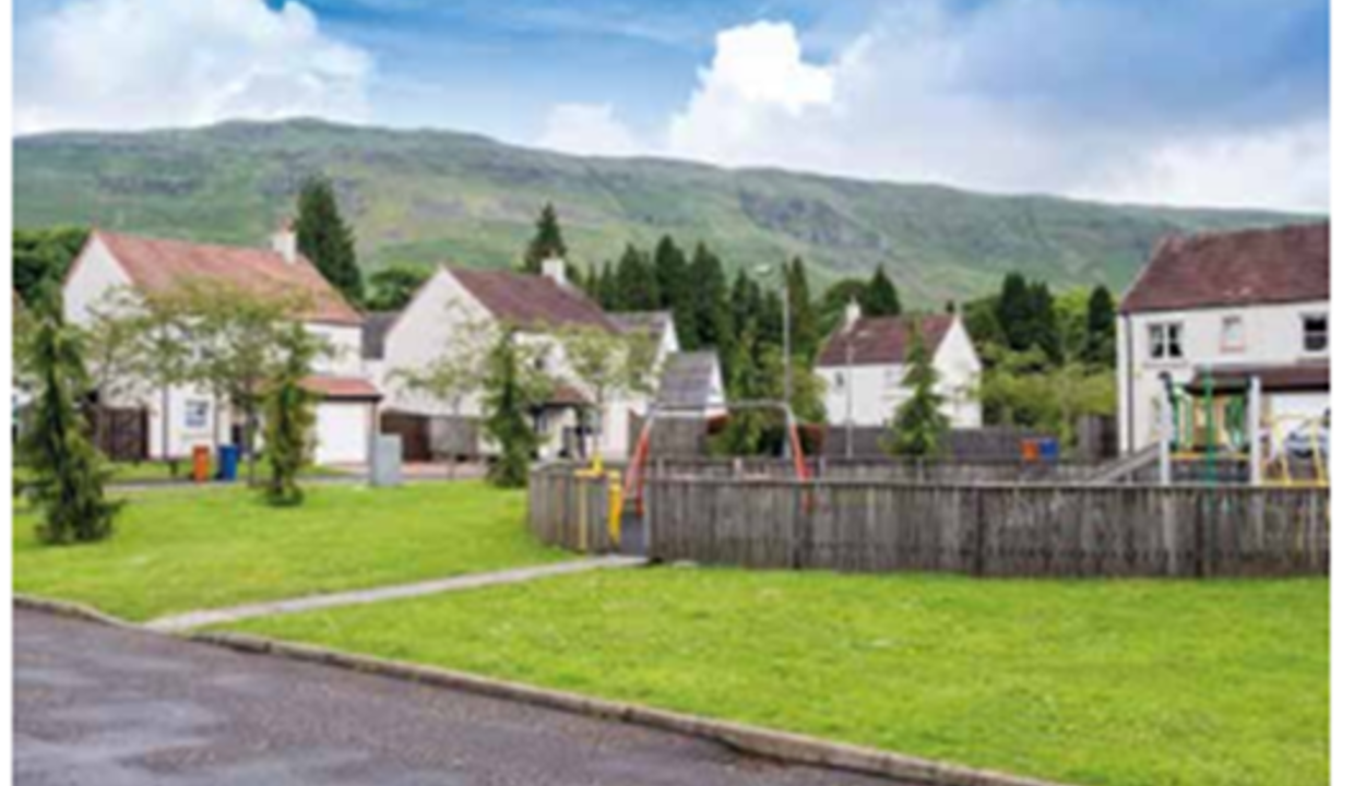 Path with walkway way to houses with grass