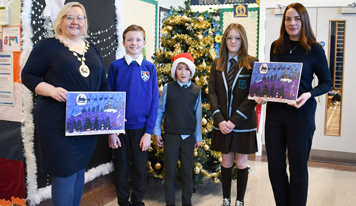 Anthony, Evan and Mya with Provost and Deputy Provost holding his winning Christmas entry