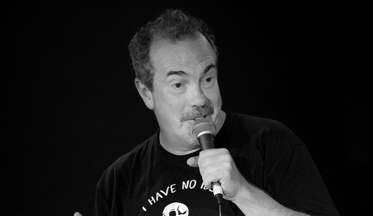 black and white picture of Gavin Mitchell holding a mic