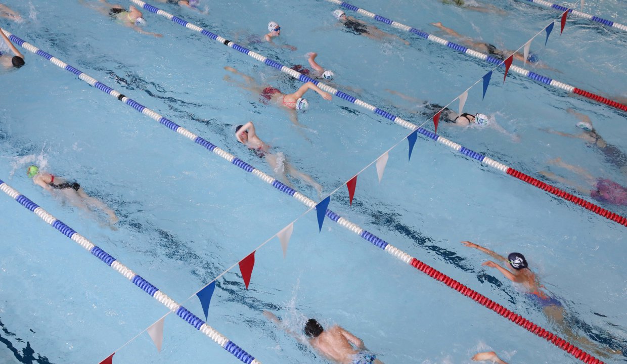 People swimming in an indoor swimming pool